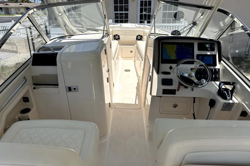 Slide: The Image of 2021 Grady-White Freedom 275 boat interior with steering console and seating. - 13