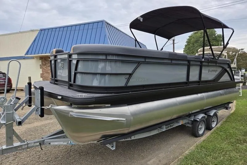 Slide: The Image of 2026 Godfrey Sweetwater 2286 SB pontoon boat on trailer, parked outdoors. - 4