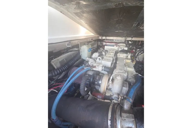 Slide: The Image of Engine compartment of a 2001 Pursuit 3000 Offshore boat, showcasing mechanical components. - 12