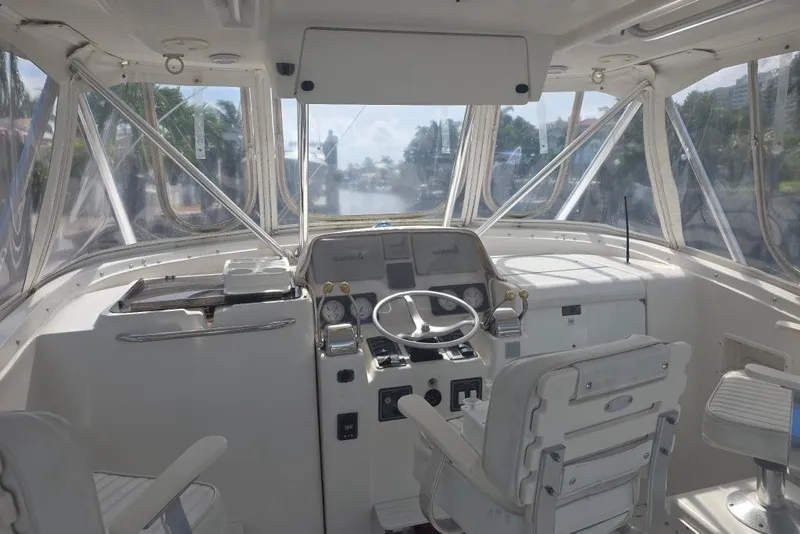 Slide: The Image of Helm of 2001 Pursuit 3000 Offshore boat with steering wheel and navigation equipment. - 3