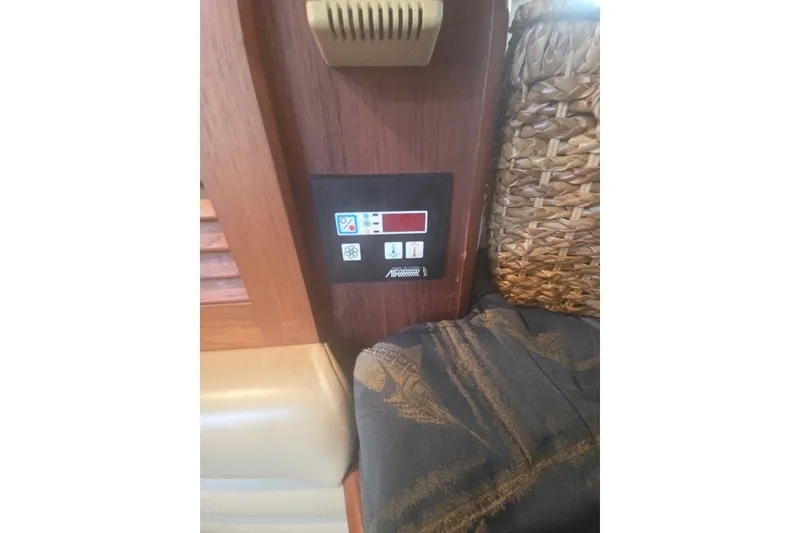 Slide: The Image of Control panel inside a 2001 Pursuit 3000 Offshore boat, featuring various function buttons. - 16