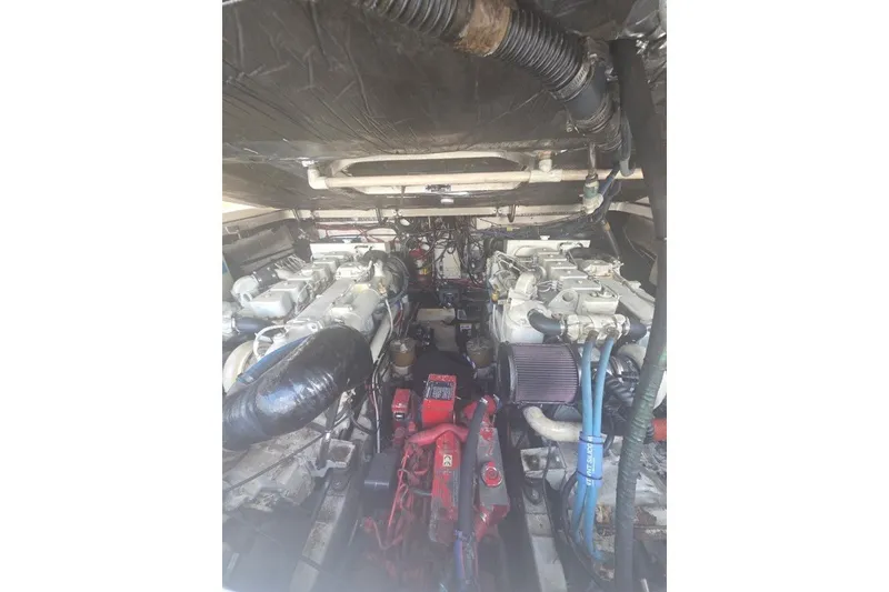 Slide: The Image of Engine compartment of a 2001 Pursuit 3000 Offshore boat, showcasing dual engines. - 10