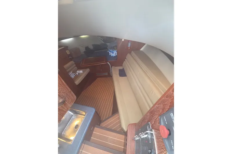 Slide: The Image of Interior of 2001 Pursuit 3000 Offshore boat with seating and wooden flooring. - 13