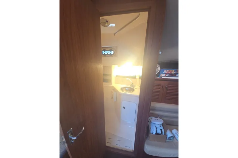 Slide: The Image of Interior view of 2001 Pursuit 3000 Offshore boat bathroom with sink and storage. - 17