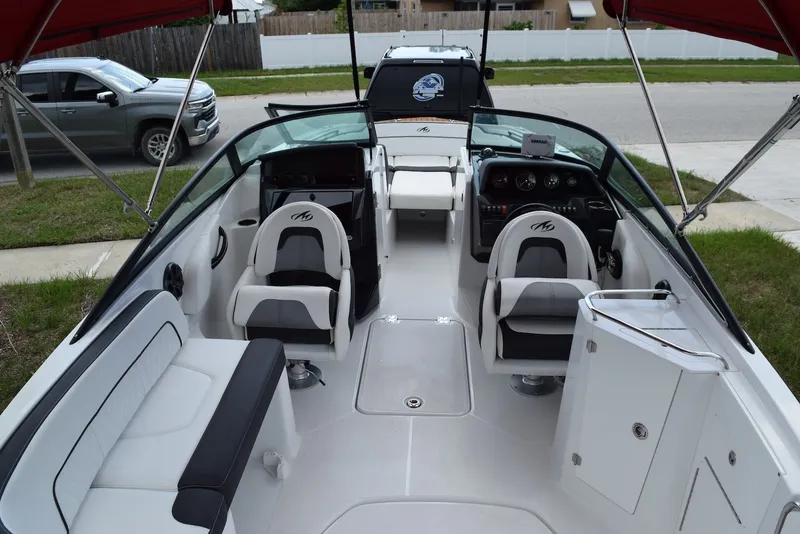 Slide: The Image of 2018 Monterey M-45 boat interior with seating, steering console, and canopy. - 9