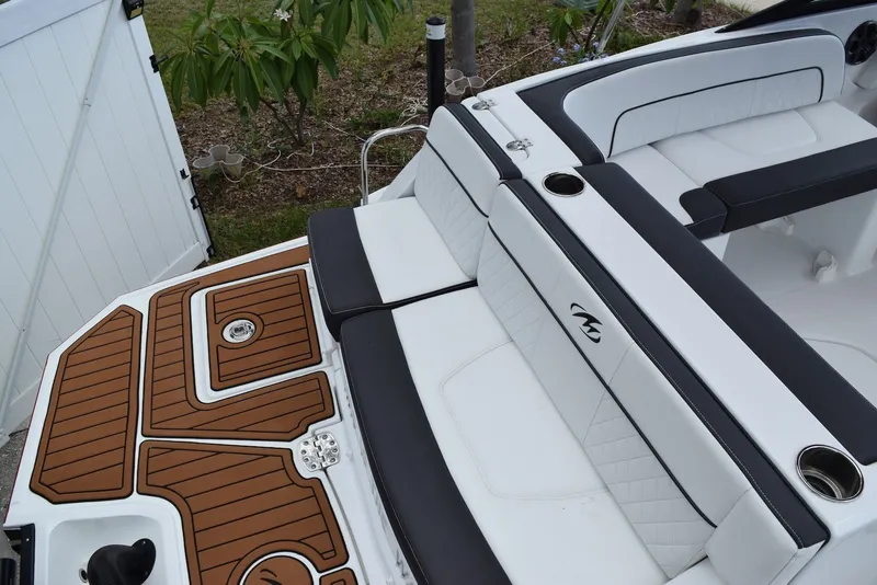 Slide: The Image of 2018 Monterey M-45 boat interior with white seating and teak-style flooring. - 5