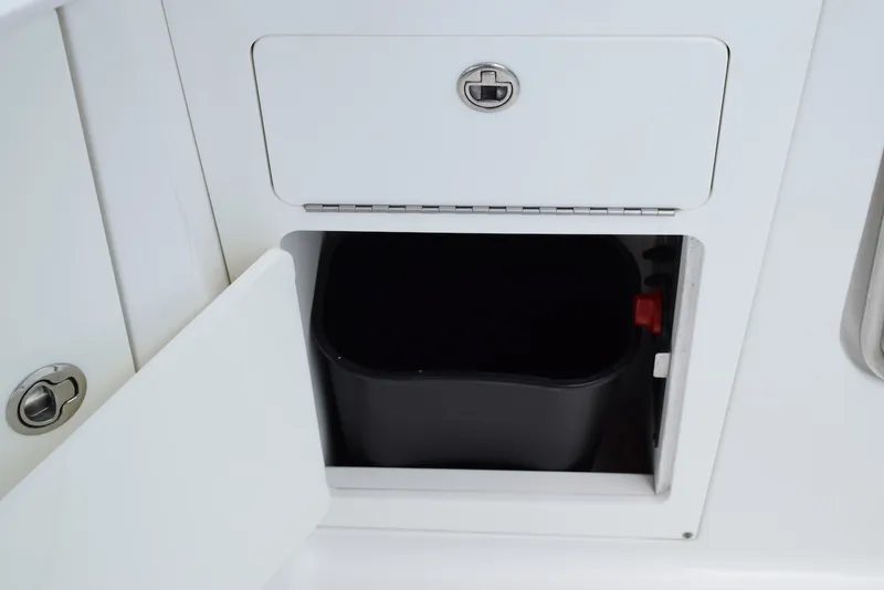 Slide: The Image of Storage compartment on a 2018 Monterey M-45 boat with a black container inside. - 24
