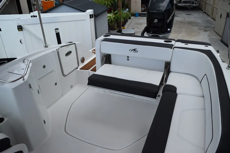 Slide: The Image of 2018 Monterey M-45 boat interior with white seating and storage compartments. - 17