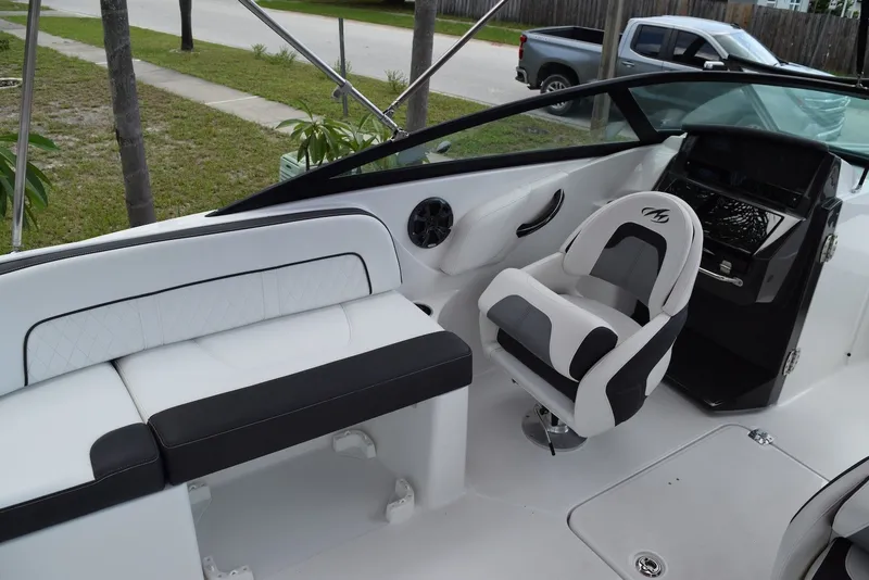 Slide: The Image of Interior of a 2018 Monterey M-45 boat with white seating and steering console. - 16