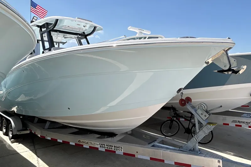 The Image of A 2027 Sea Fox 328 Commander on a trailer, with an American flag in the background. - 0