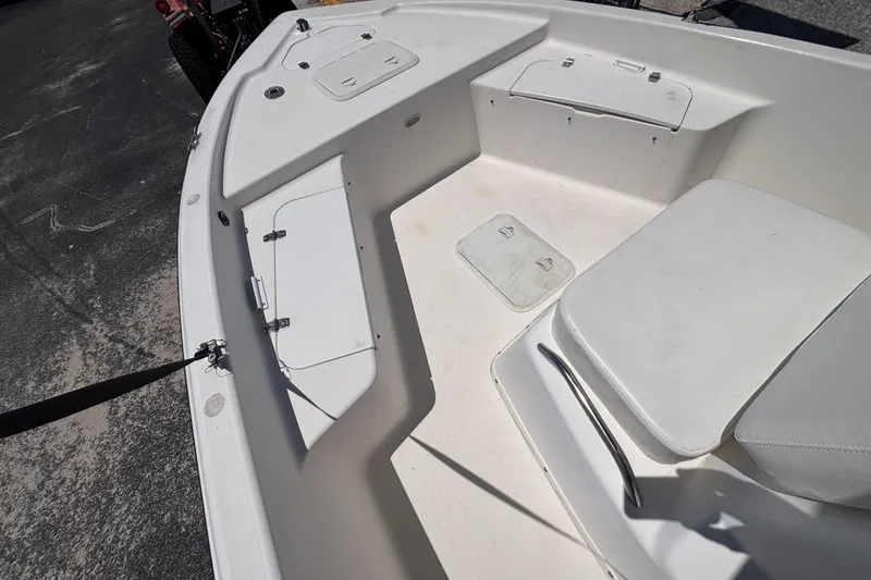 Slide: The Image of Interior view of a 2001 Century 1900 Inshore boat, featuring seating and storage compartments. - 21