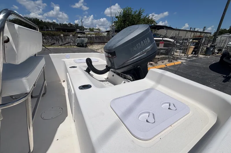 Slide: The Image of Century 1900 Inshore boat, 2001 model, with Yamaha outboard motor, docked under clear skies. - 15