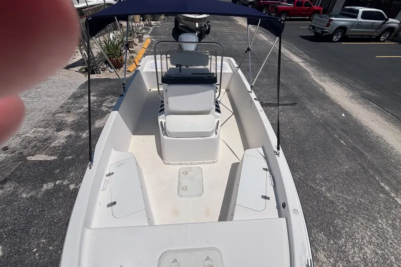 Slide: The Image of 2001 Century 1900 Inshore boat with canopy, parked on asphalt. - 24