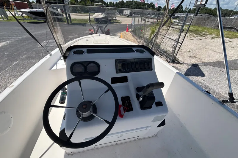 Slide: The Image of Century 1900 Inshore 2001 boat cockpit with steering wheel and control panel. - 16