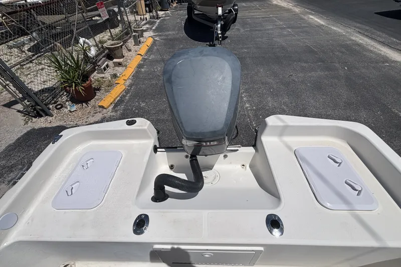 Slide: The Image of Century 1900 Inshore boat, 2001 model, featuring an outboard motor and storage compartments. - 19