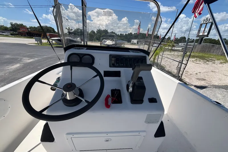 Slide: The Image of Century 1900 Inshore 2001 boat console with steering wheel and throttle controls. - 28