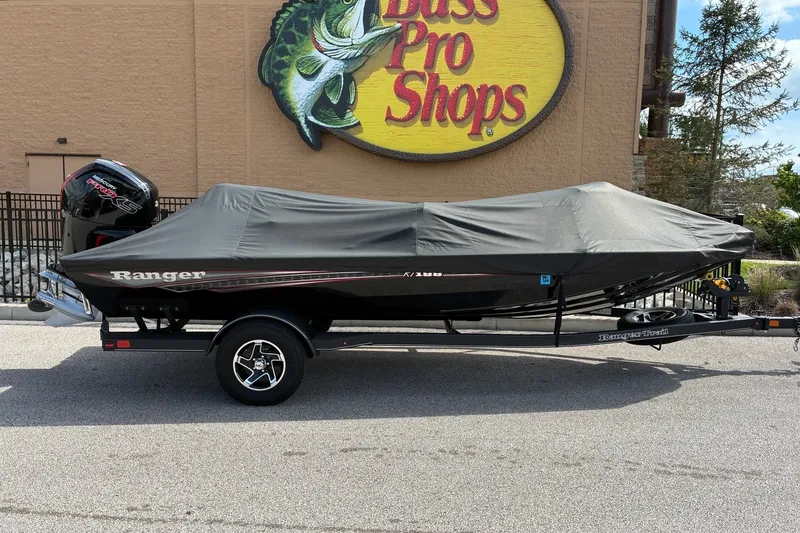 Slide: The Image of 2023 Ranger RT188 boat covered on trailer outside Bass Pro Shops. - 19