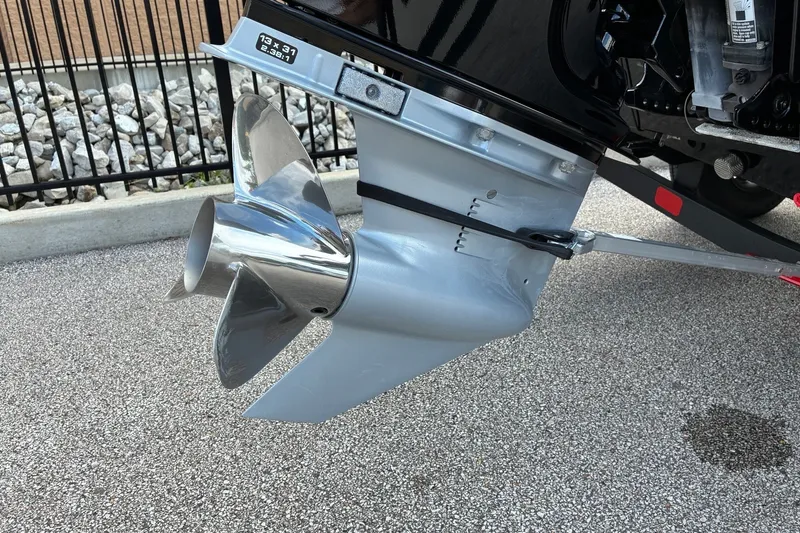 Slide: The Image of 2023 Ranger RT188 boat propeller, shiny metal finish, parked on gravel surface. - 5