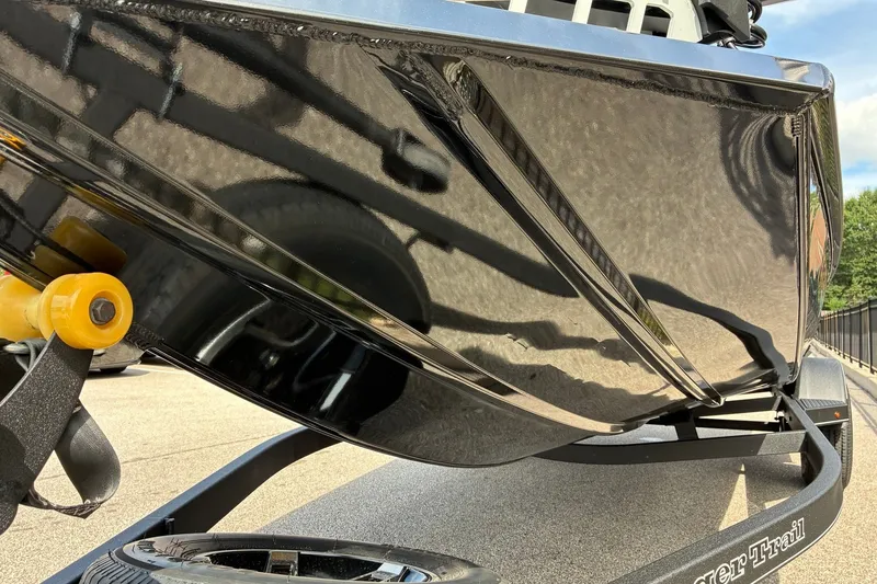 Slide: The Image of 2023 Ranger RT188 boat hull on trailer, showcasing sleek black design and craftsmanship. - 9