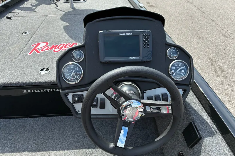 Slide: The Image of 2023 Ranger RT188 boat dashboard with steering wheel and Lowrance display. - 13