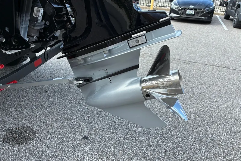 Slide: The Image of 2023 Ranger RT188 boat propeller and motor detail in a parking lot. - 3