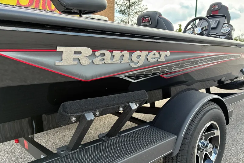 Slide: The Image of 2023 Ranger RT188 boat, sleek black design with red accents, close-up side view. - 1
