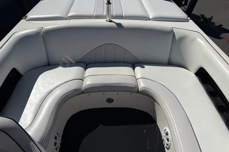 Slide: The Image of 2004 MB B-52 boat interior with white cushioned seating and cup holders. - 16