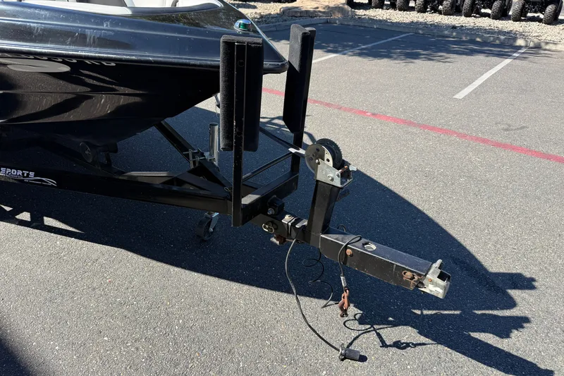 Slide: The Image of Trailer hitch of a 2004 MB B-52 boat on asphalt parking lot. - 10