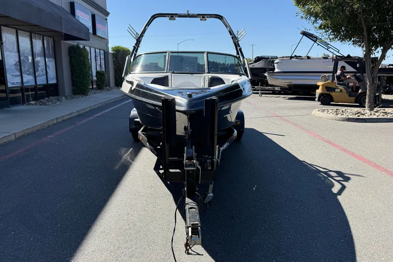 Slide: The Image of 2004 MB B-52 boat on trailer in parking lot, sunny day. - 8