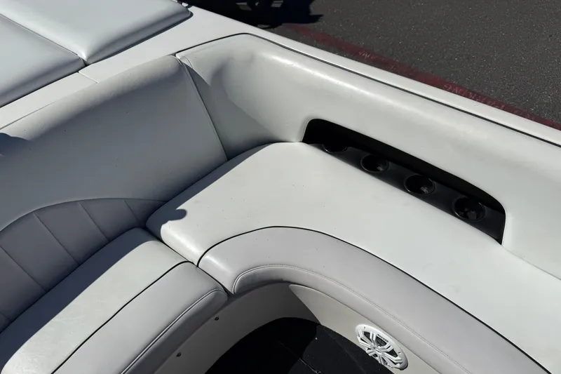 Slide: The Image of 2004 MB B-52 boat interior with white cushioned seating and cup holders. - 17