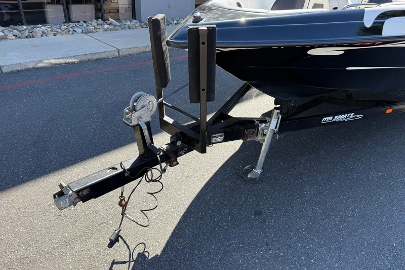 Slide: The Image of Trailer hitch of a 2004 MB B-52 boat on pavement. - 9