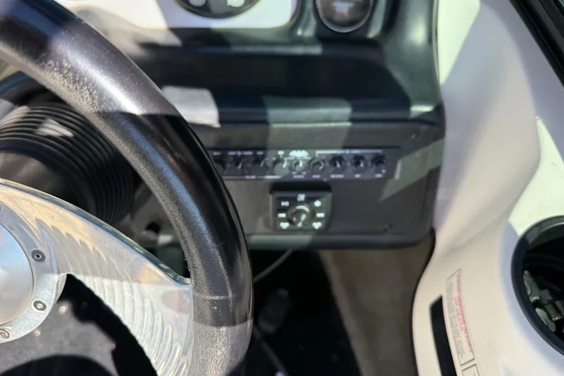 Slide: The Image of Steering wheel and dashboard controls of a 2004 MB B-52 boat. - 21