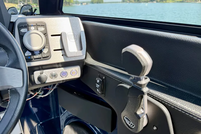 Slide: The Image of Dashboard of 2022 Malibu Wakesetter 23 MXZ boat with control panel and steering wheel. - 17