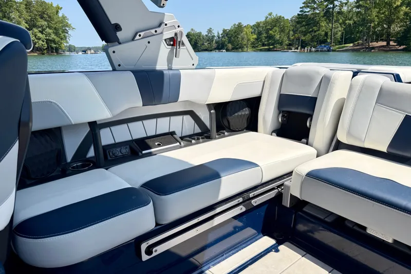 Slide: The Image of Interior of 2022 Malibu Wakesetter 23 MXZ boat with luxurious seating by a lake. - 22