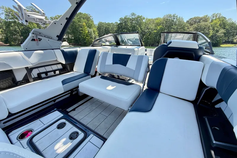 Slide: The Image of Interior of 2022 Malibu Wakesetter 23 MXZ boat with luxurious seating and lake view. - 11