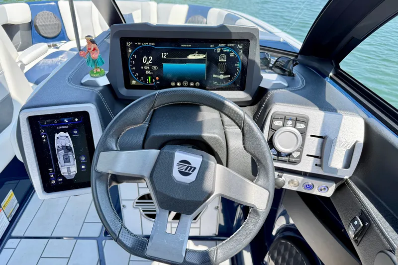 Slide: The Image of 2022 Malibu Wakesetter 23 MXZ dashboard with advanced controls and digital displays. - 14