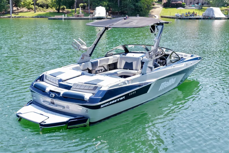 Slide: The Image of 2022 Malibu Wakesetter 23 MXZ boat on a serene lake. - 4