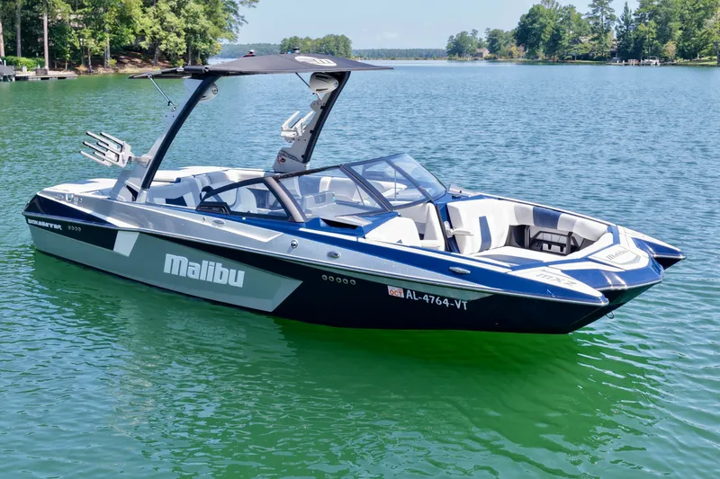 Slide: The Image of 2022 Malibu Wakesetter 23 MXZ boat on a serene lake. - 7