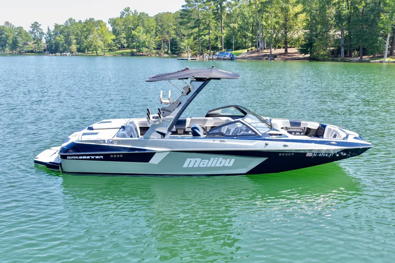 Slide: The Image of 2022 Malibu Wakesetter 23 MXZ boat on a serene lake. - 6