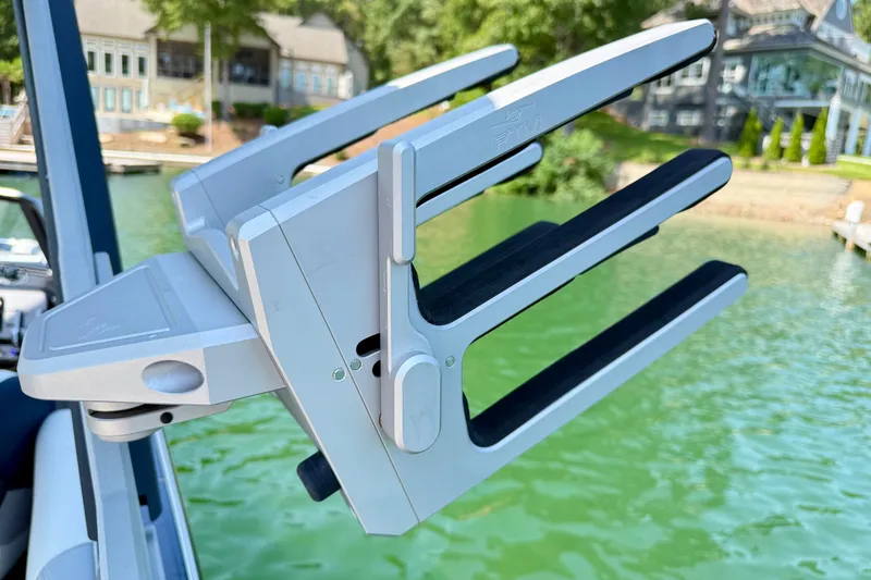 Slide: The Image of Wakeboard rack on 2022 Malibu Wakesetter 23 MXZ, near a serene lakeside setting. - 29