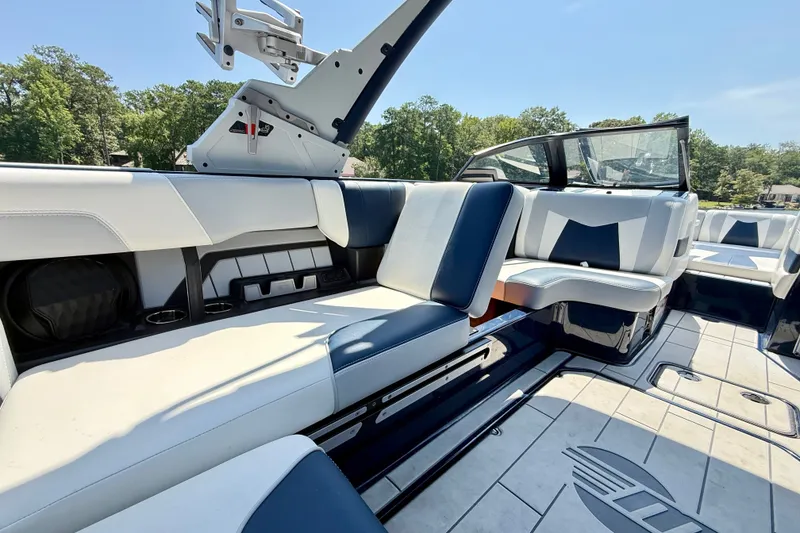 Slide: The Image of 2022 Malibu Wakesetter 23 MXZ interior with sleek seating and modern design. - 26