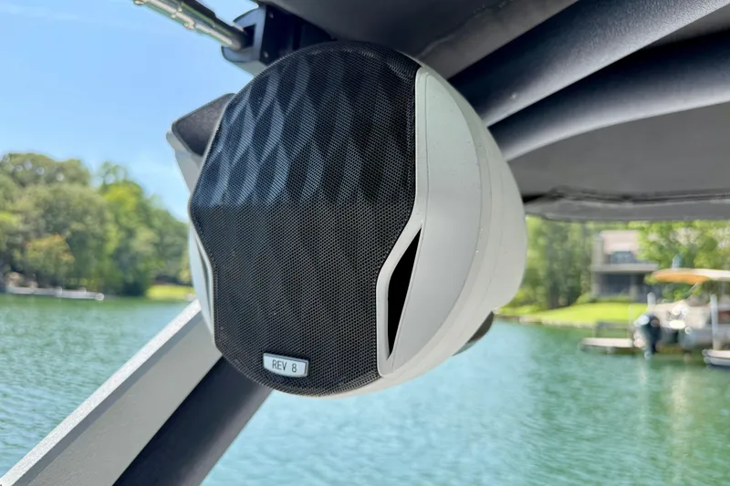 Slide: The Image of Boat speaker on Malibu Wakesetter 23 MXZ, 2022, with lake view background. - 30