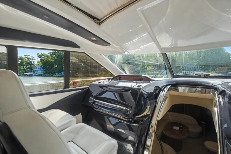 Slide: The Image of Interior view of a 2001 Viking Sport Cruisers V65 yacht, featuring luxurious seating and scenic windows. - 29
