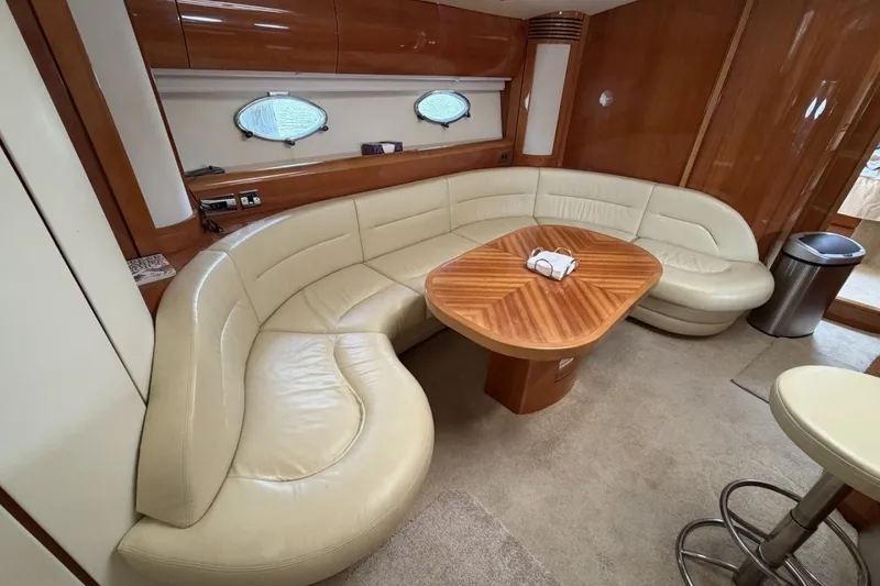 Slide: The Image of Luxurious interior of 2001 Viking Sport Cruisers V65 with leather seating and wooden table. - 63