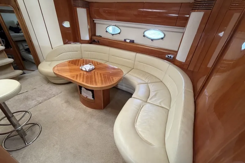Slide: The Image of Luxurious interior of 2001 Viking Sport Cruisers V65 with leather seating and wooden table. - 66