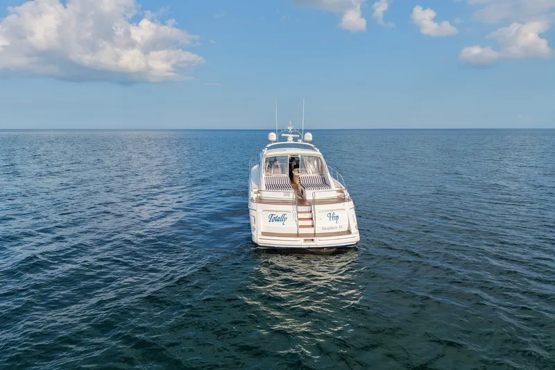 Slide: The Image of 2001 Viking Sport Cruisers V65 yacht on open sea under blue sky. - 11