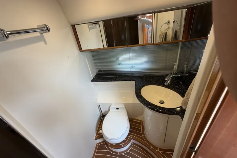 Slide: The Image of Luxurious bathroom in 2001 Viking Sport Cruisers V65 yacht with modern fixtures and elegant design. - 46