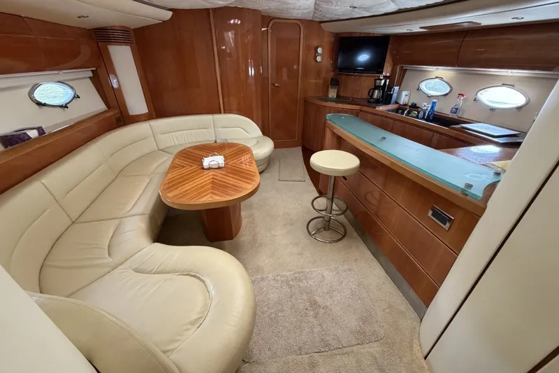 Slide: The Image of Luxurious interior of a 2001 Viking Sport Cruisers V65 yacht with elegant seating and bar area. - 60