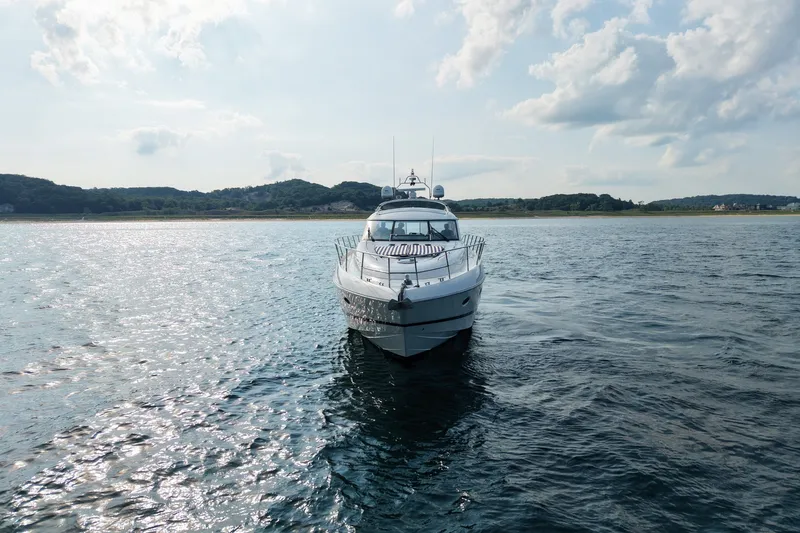 Slide: The Image of 2001 Viking Sport Cruisers V65 yacht on open water under a partly cloudy sky. - 10