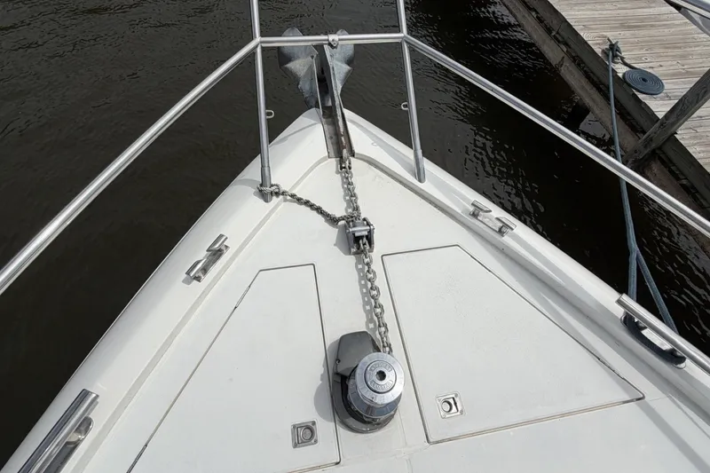 Slide: The Image of Bow of 2001 Viking Sport Cruisers V65 yacht with anchor chain and railing. - 62